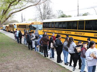 Students lined up outside near the bus at Hiram Johnson